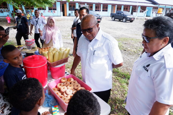 
					Penjabat Bupati Kepulauan Yapen, Welliam Manderi tengah belanja di bazar SD Kristen Charis Yapen, Rabu 31 Januari 2024. (KabarPapua.co/Ainun Faathirjal)