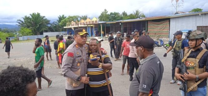 
					Kapolres Nduga, AKBP V.J Parapaga menenangkan seorang warga dalam aksi saling serang akibat perebutan suara caleg. (Foto: Polda Papua)