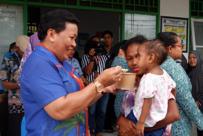 
					Sekda Kepulauan Yapen, Erny Tania memberikan makanan tambahan pada anak stunting di Pustu Anotourei, Kamis 2 Mei 2024. (KabarPapua.co/Ainun Faathirjal)