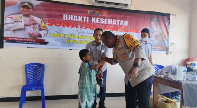 
					Kapolres Jayapura, AKBP Umar Nasatekay saat memberikan bingkisan kepada salah satu anak yang ikut sunatan massal. Foto: Katharina/Kabarpapua.co