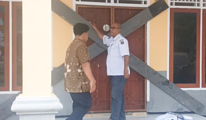 
					Kadisperindagkop dan UKM Kabupaten Kaimana, Agustinus Janoma dibantu staf saat membuka palang. (KabarPapua.co/Yosias Wambrauw)