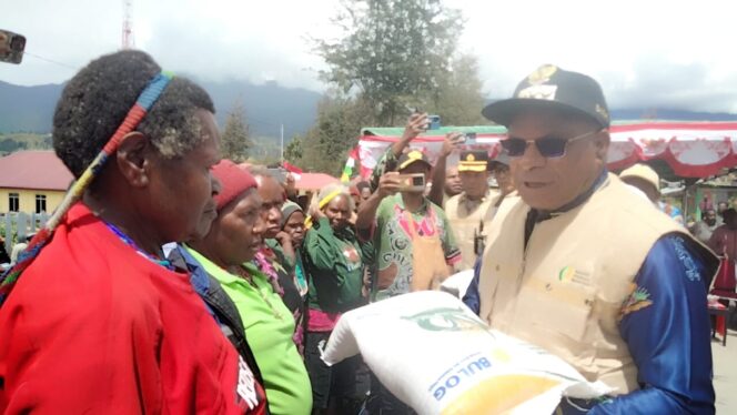 
					Bupati Puncak Elvis Tabuni saat menyerahkan bantuan beras dari pemerintah. Foto: Diskominfo Puncak