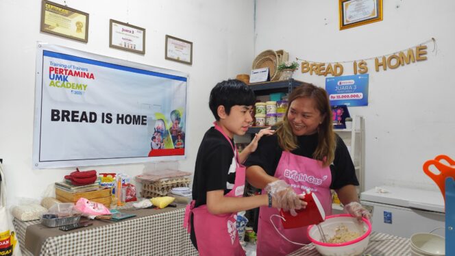 
					Juliawati Harimu, founder Amae Cookies bersama sang buah hari Gio saat membuat camilan di ruah produksinya. Foto: Katharina Lita/Kabarpapua.co