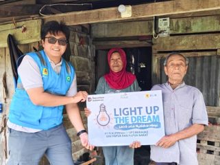 Petugas PLN serahkan simbolis program Light Up The Dream kepada Karyo Sudarmo, menandai penyerahan resmi instalasi listrik gratis bagi keluarga Karyo di Tanah Miring, Merauke, Papua Selatan. (Foto dok: PLN UIW Papua dan Papua Barat)