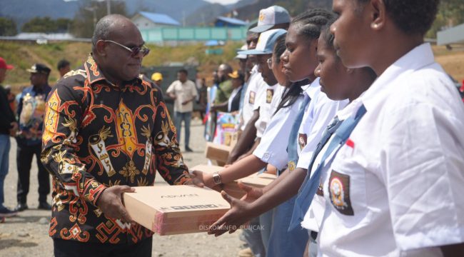 Gubernur Papua Tengah, Meki Nawipa menyerahkan 20 laptop kepada para siswa di Ilaga. Foto: Diskominfo Puncak 